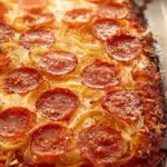 Cheesy crunchy onion rings served with a dipping sauce