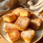 Delicious plate of Fried Milk dessert topped with a dusting of powdered sugar