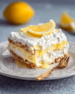 No-Bake Lemon Icebox Cake 5 Delicious no-bake lemon icebox cake topped with whipped cream and lemon slices.