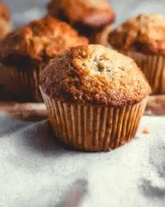 Freshly baked vegan banana muffins on a cooling rack