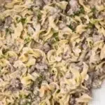 30-minute ground beef stroganoff served in a bowl with noodles and herbs