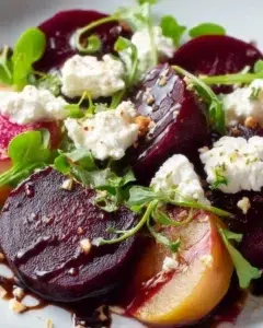 Colorful beet salad with goat cheese and balsamic dressing served in a bowl
