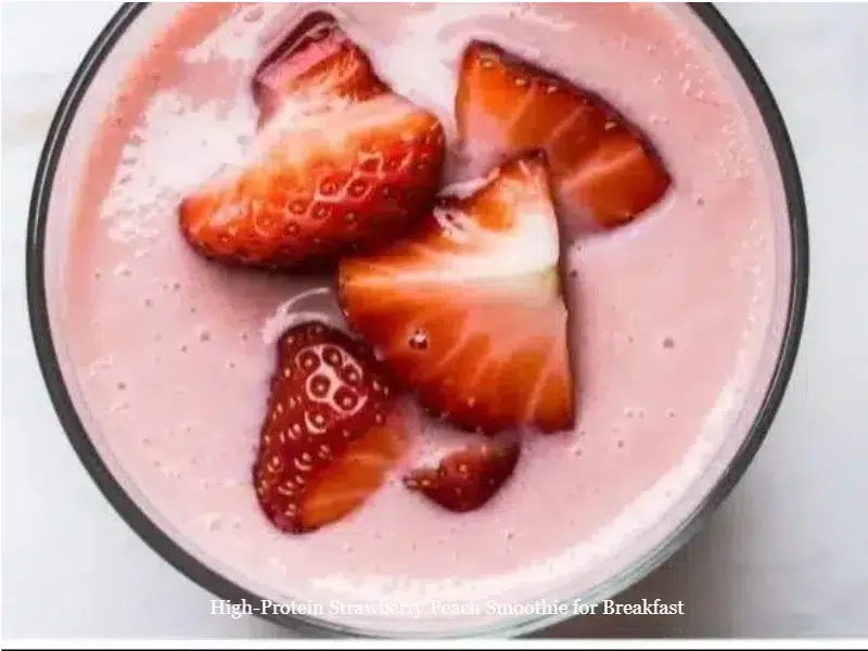 High-protein strawberry peach smoothie in a glass with fresh fruit