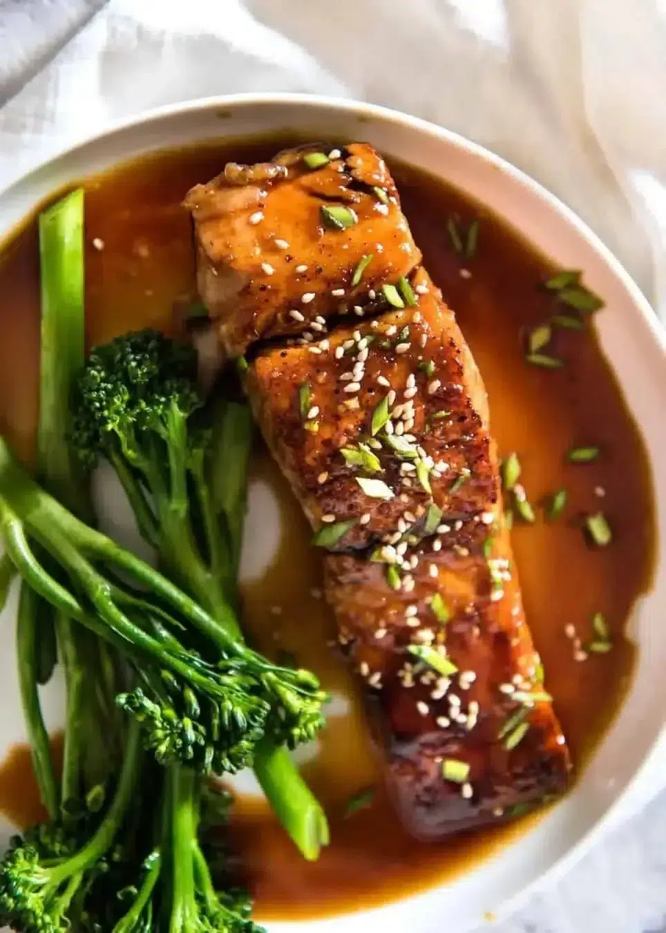 Delicious honey garlic salmon fillet garnished with herbs