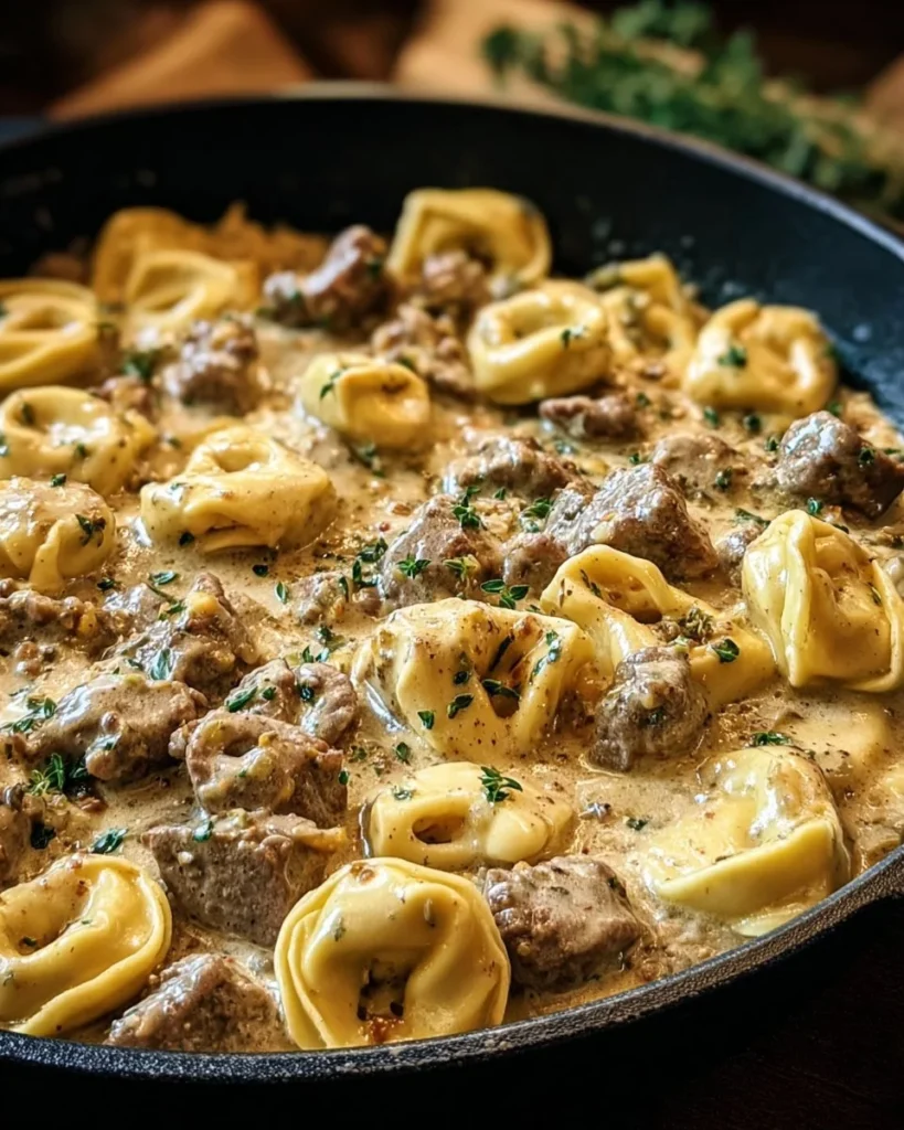 Creamy one-skillet beef stroganoff tortellini served with fresh herbs.