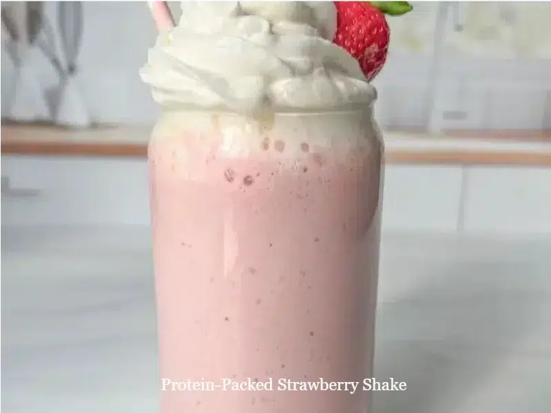 Protein-packed strawberry shake in a glass with fresh strawberries