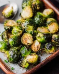 Roasted Brussels Sprouts 7 Roasted Brussels sprouts served on a plate with olive oil and seasoning