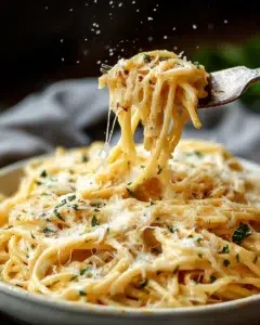 Plate of cheesy spaghetti with garlic and parmesan cheese