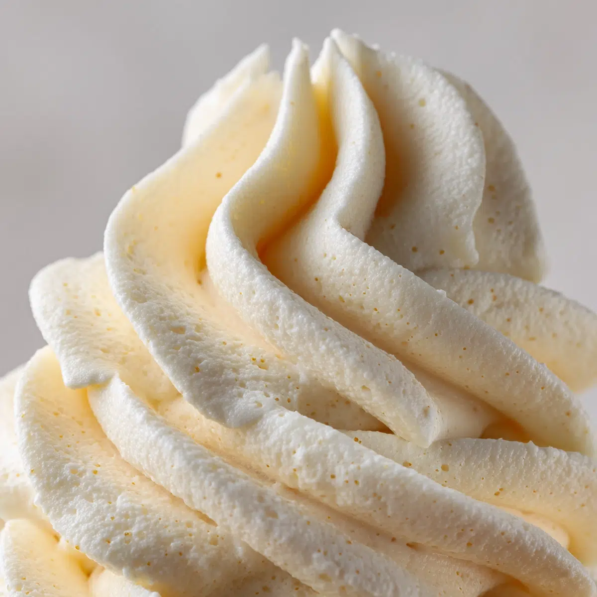 close up macro shot of cream cheese frosting recipe showing texture and seasoning