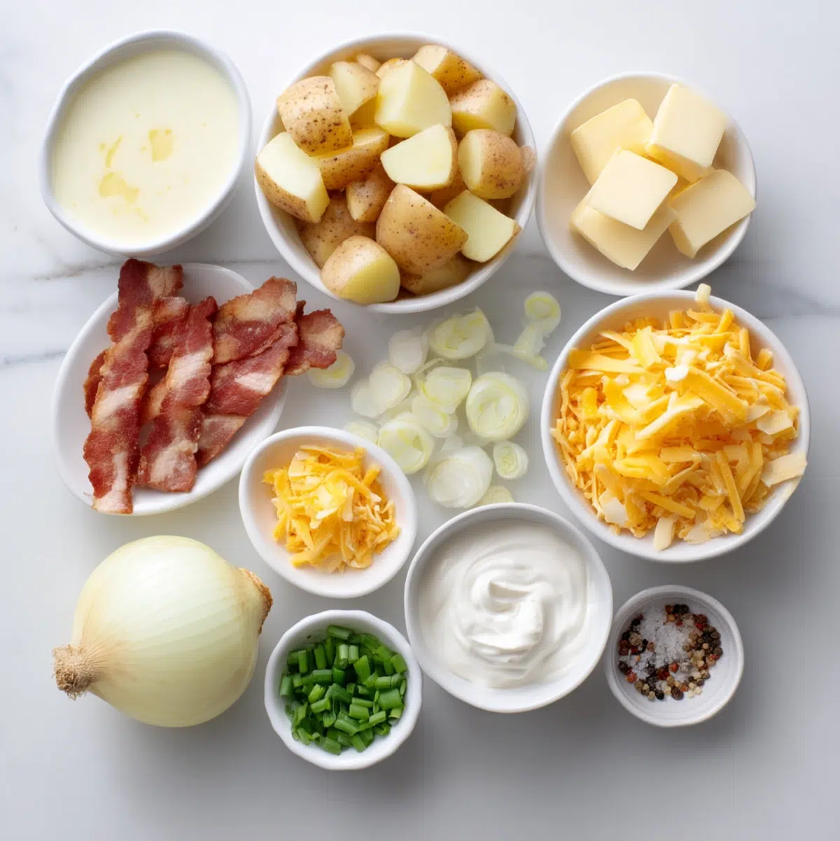 ingredients for potato soup recipe arranged in prep bowls overhead view