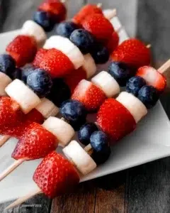 Patriotic fruit skewers arranged in red, white, and blue colors for a festive celebration