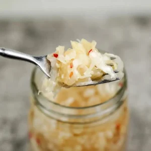 Homemade sauerkraut in a jar, showcasing the fermented cabbage process