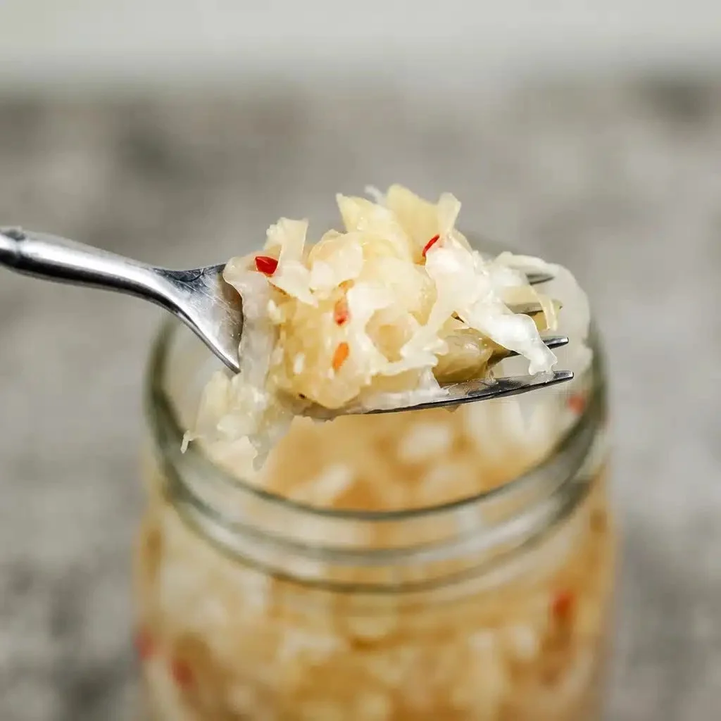Homemade sauerkraut in a jar, showcasing the fermented cabbage process