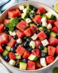 Watermelon Feta Salad topped with fresh mint leaves